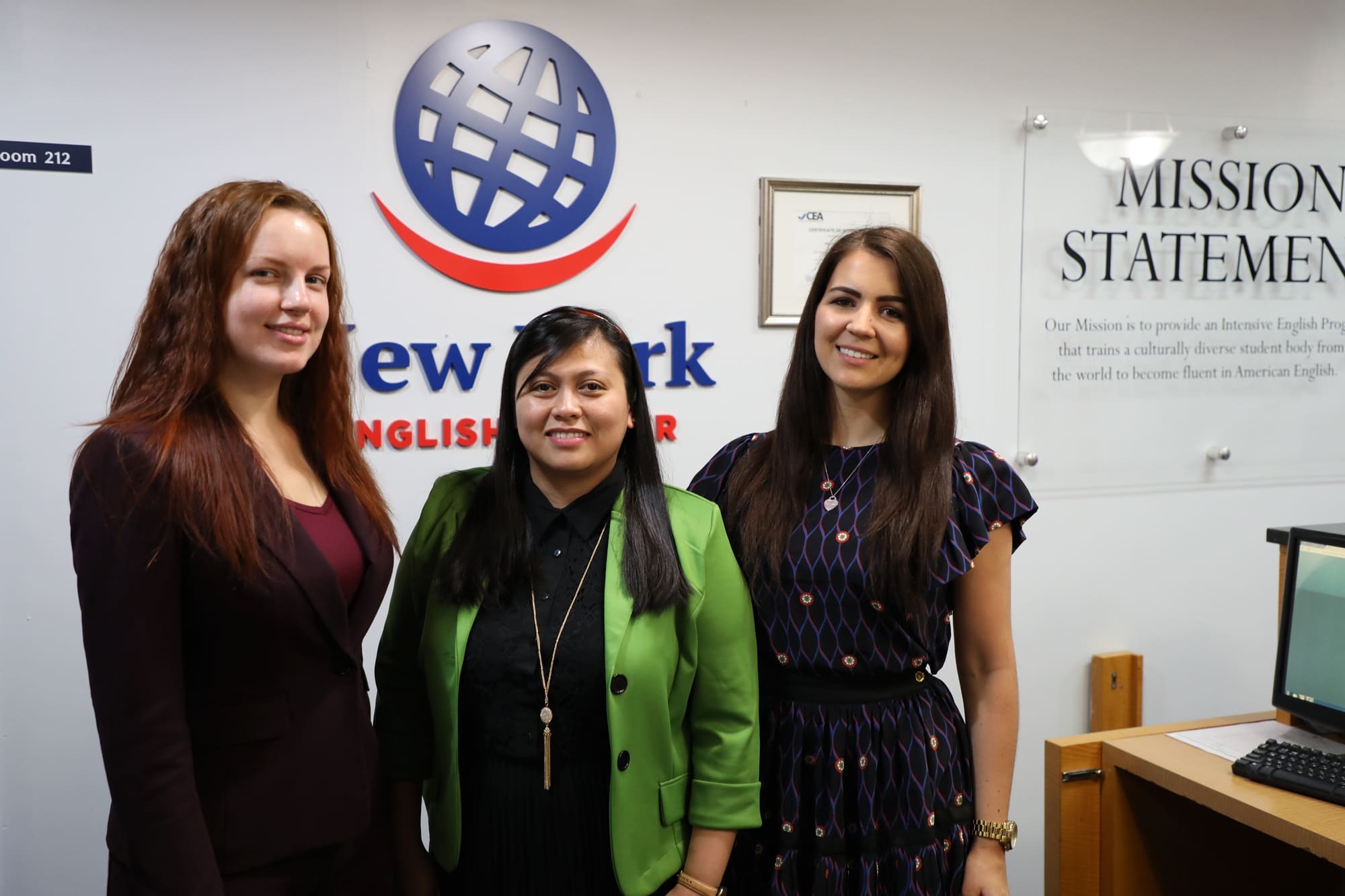 Three women posing for a photo at New York English Center