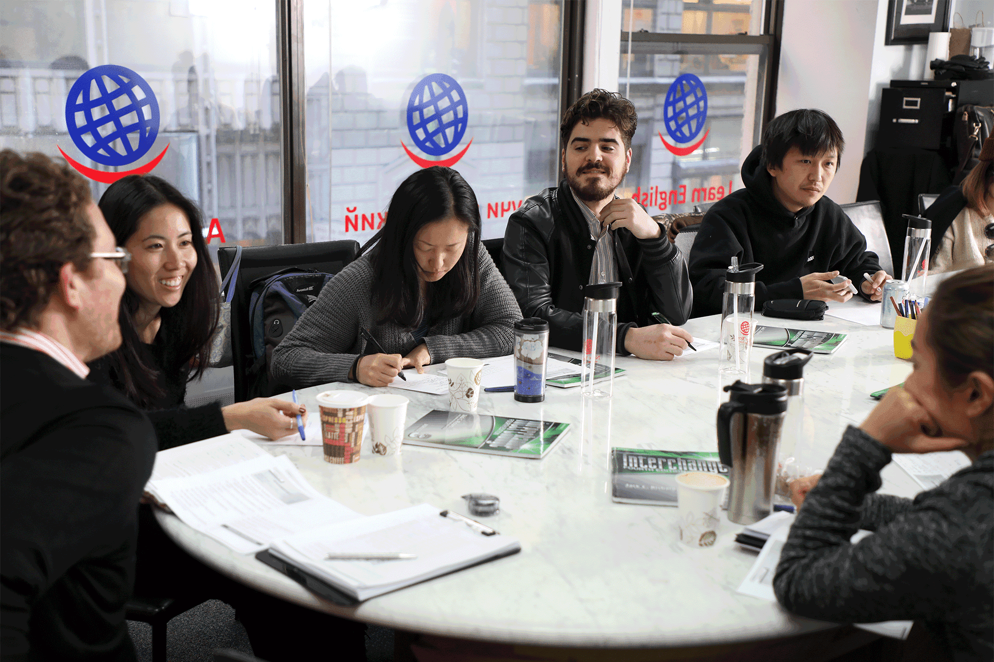 Students at the New York English Center gathered around a table for a study session.